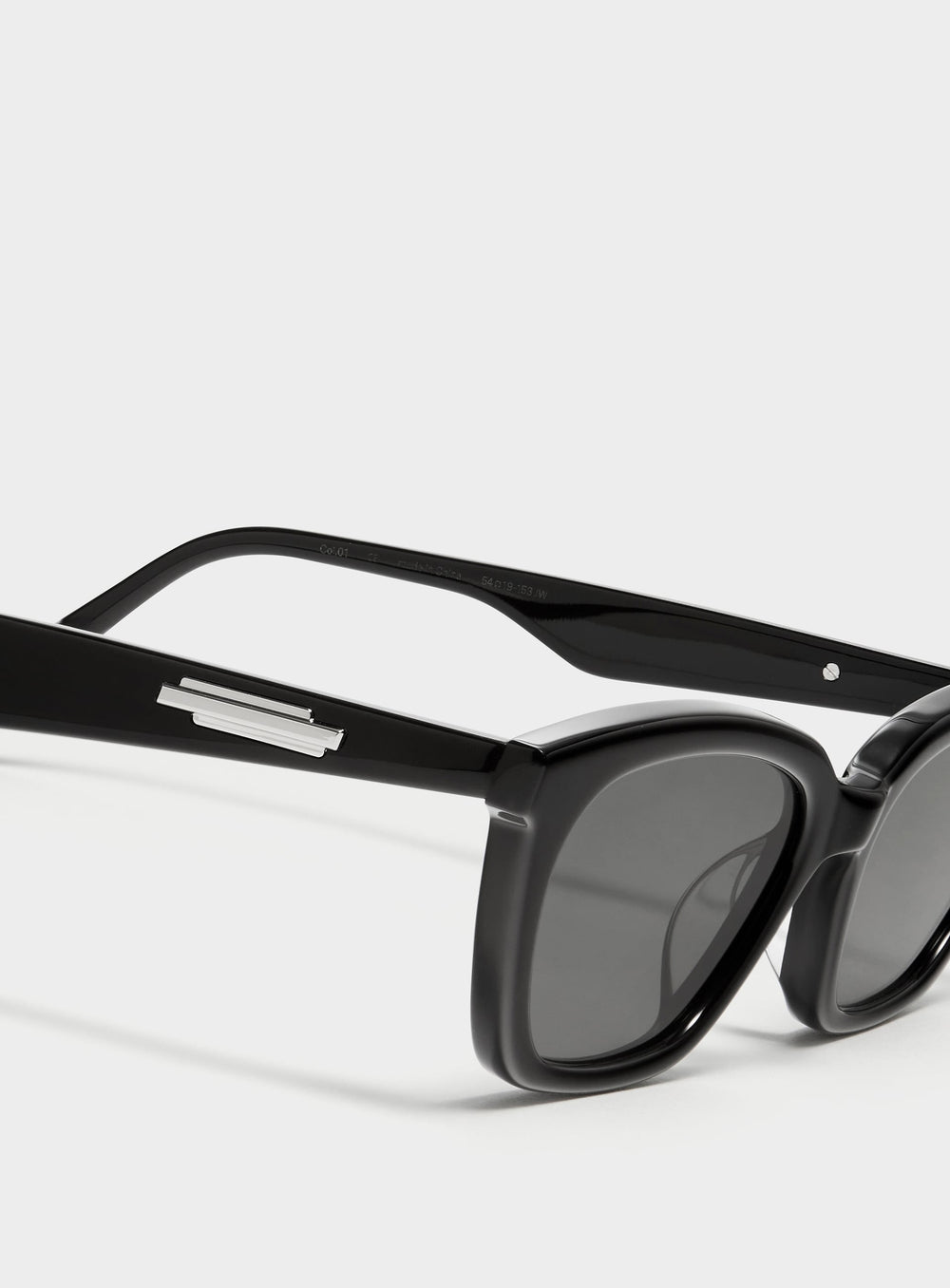 Close-up of Lust in black cat-eye Sunglasses lenses, high-quality eyewear by Mercury Retrograde Burr Puzzle Collection 