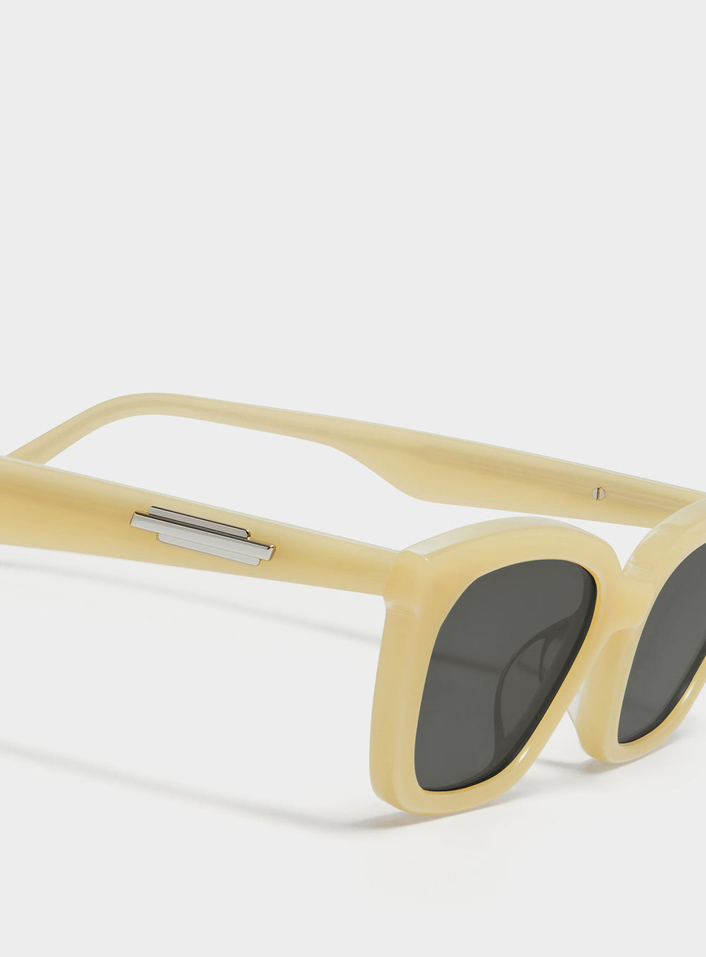 Close-up of Lust in yellow cat-eye Sunglasses lenses, high-quality eyewear by Mercury Retrograde Burr Puzzle Collection 