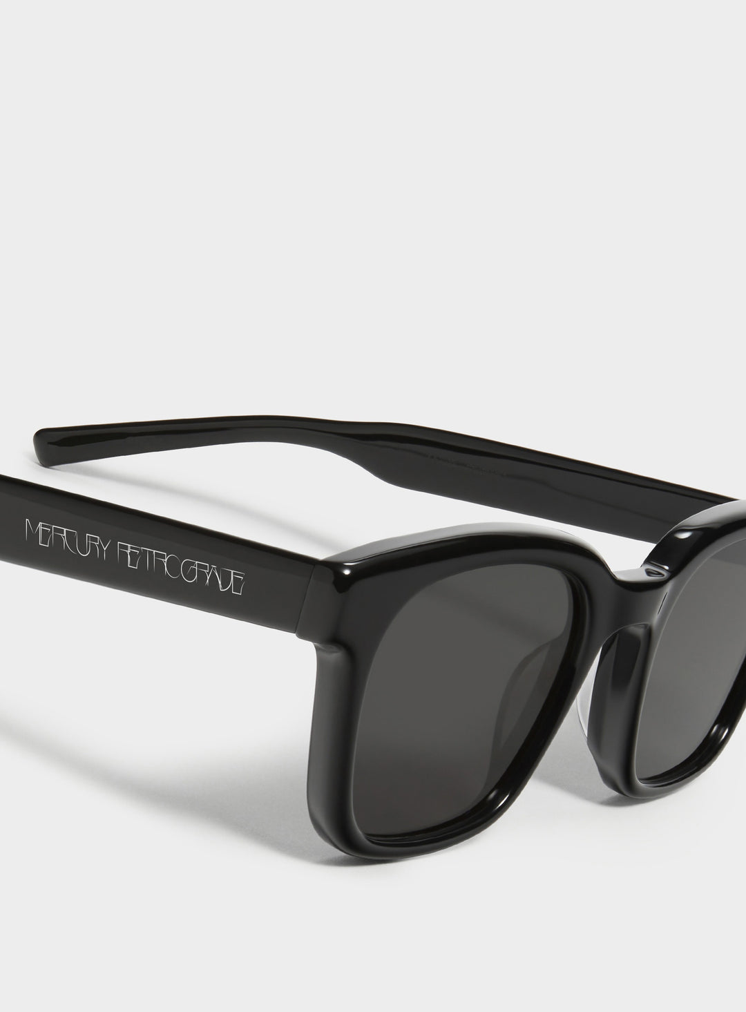 Close-up of Bubblegum in black square Sunglasses lenses, high-quality eyewear by Mercury Retrograde