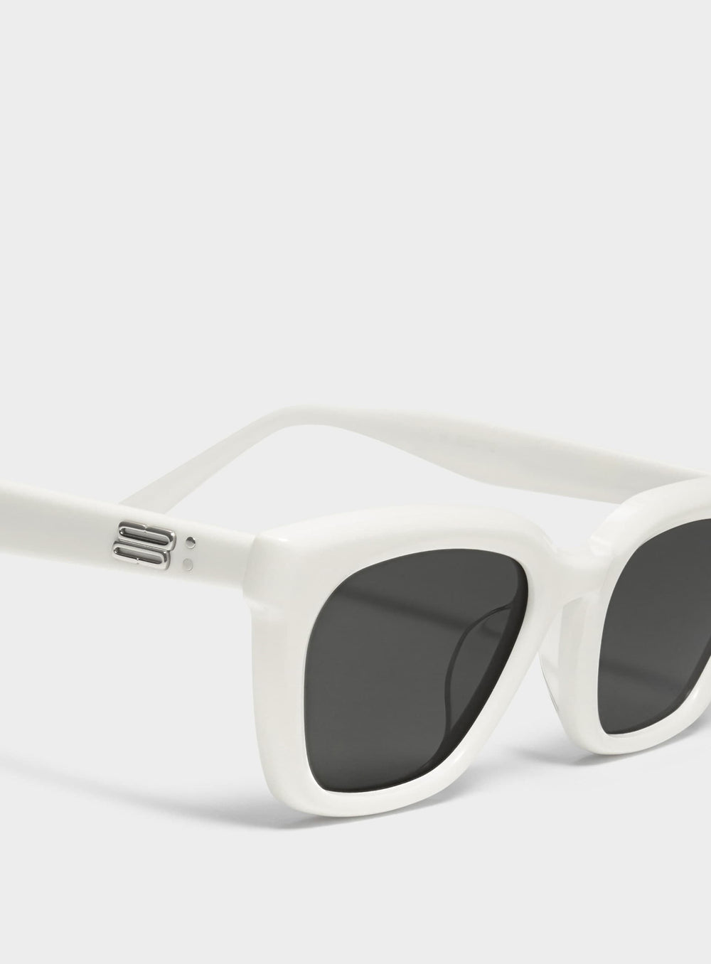 Close-up of Shadow in white square Sunglasses lenses, high-quality eyewear by Mercury Retrograde Burr Puzzle Collection 