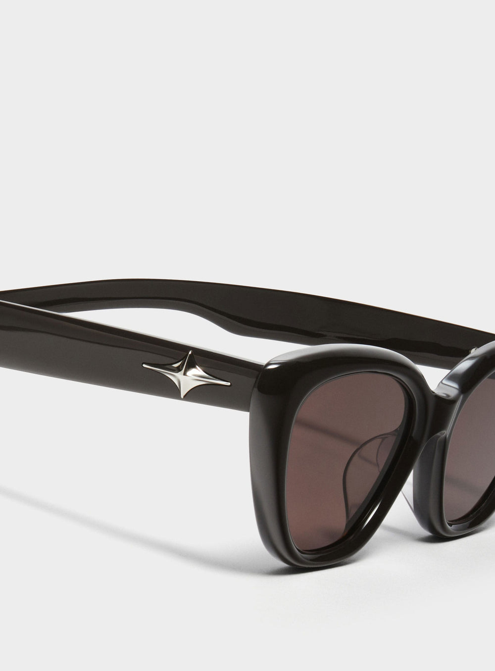Close-up of Virgo in black cat-eye Sunglasses lenses, high-quality eyewear by Mercury Retrograde Galaxy Collection 