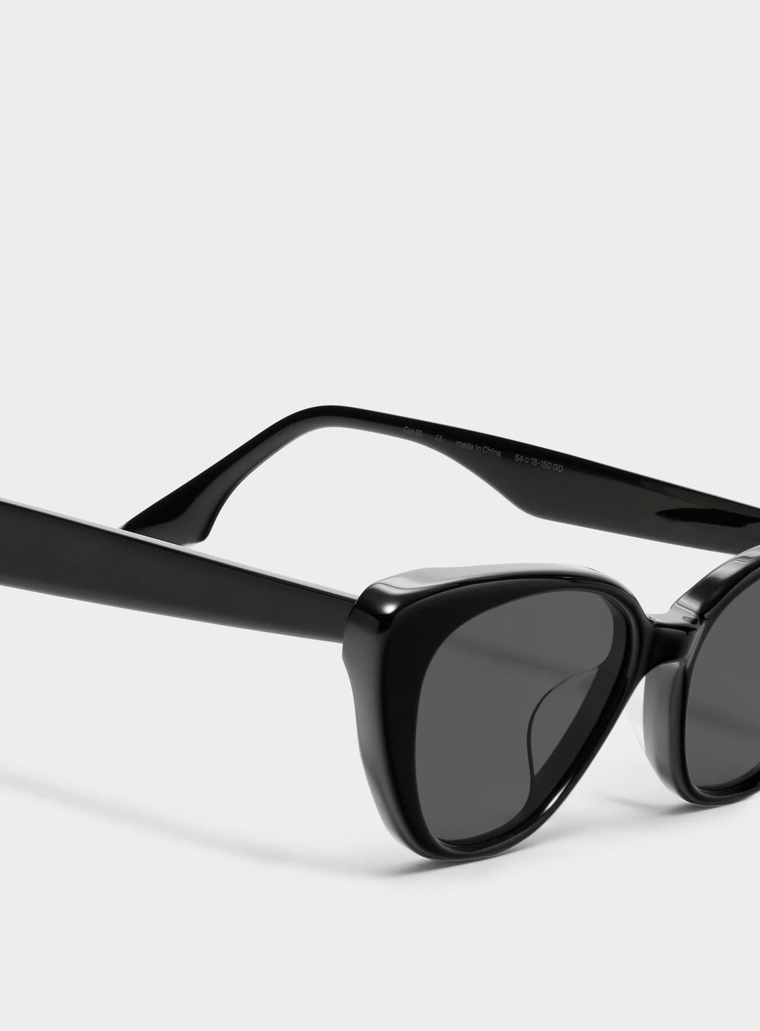 Close-up of Dawn in black cat-eye Sunglasses lenses, high-quality eyewear by Mercury Retrograde Daydream Collection 