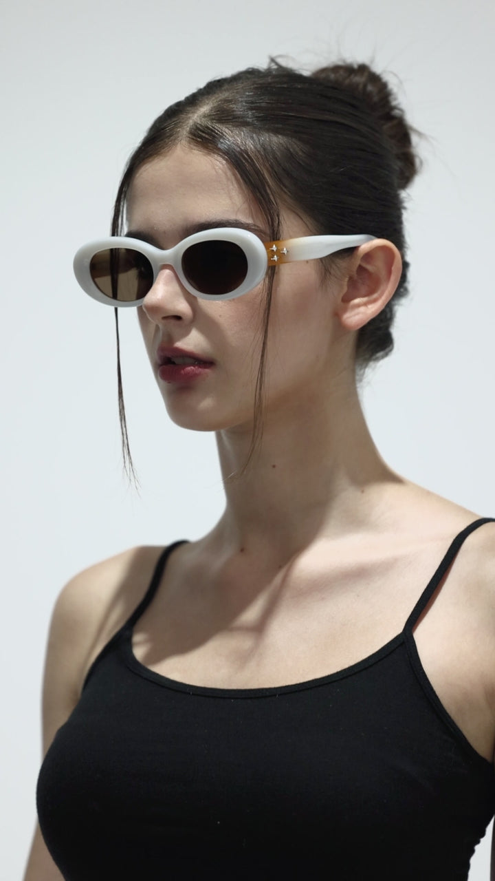 Walking model wearing Triangulum in white round stylish Sunglasses from Mercury Retrograde Galaxy Collection 