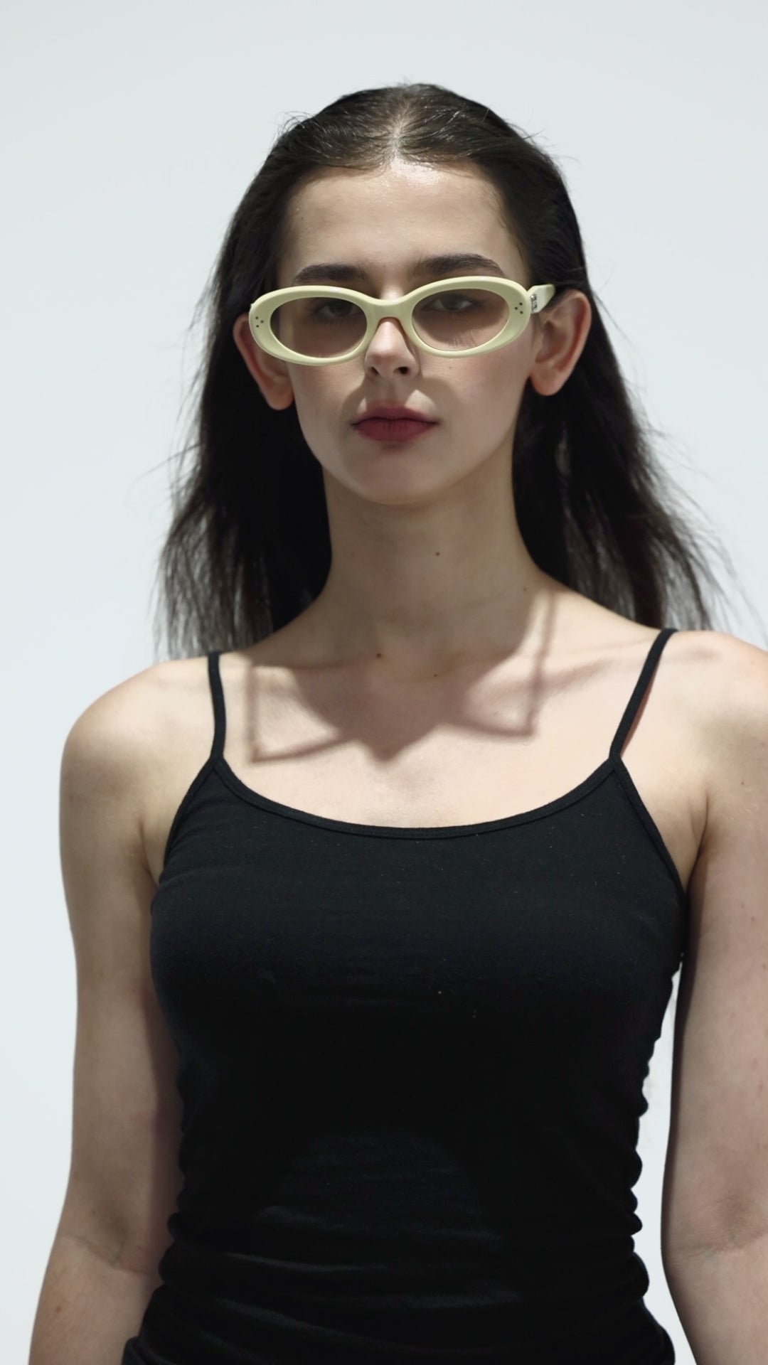 Walking model wearing her Breath in light yellow K-pop style round Sunglasses for fashionistas from Mercury Retrograde Burr Puzzle Collection 