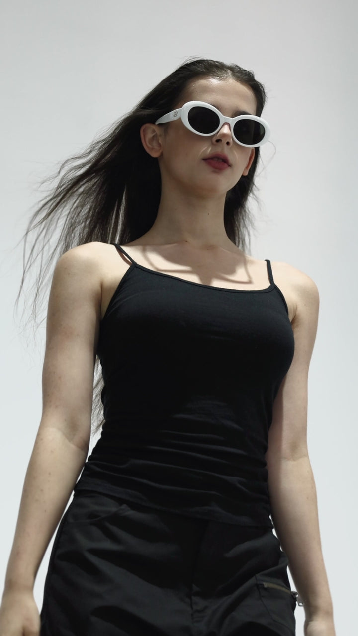Walking model wearing Poison in white round  Designer Sunglasses from Mercury Retrograde Burr Puzzle Collection 
