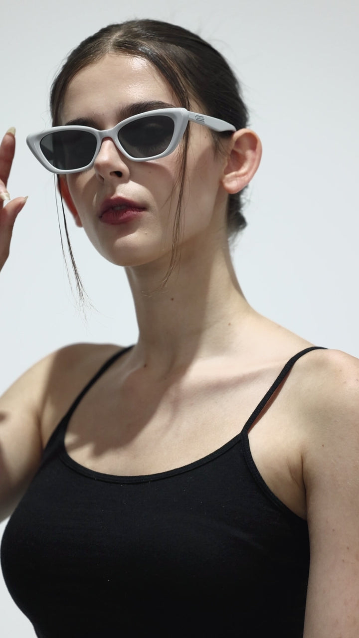 Walking model wearing California in grey cat-eye Designer Sunglasses with UV protection from Mercury Retrograde Burr Puzzle Collection 