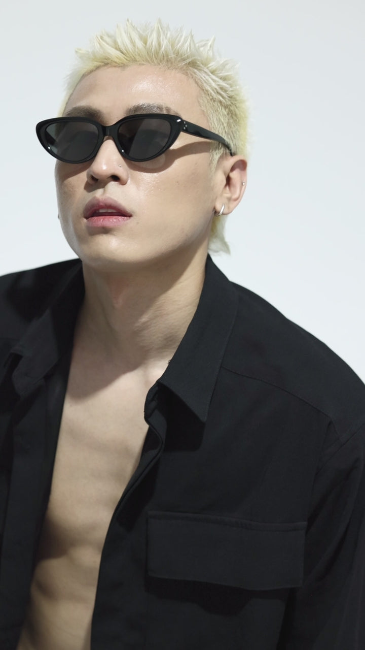 Walking male model wearing Daydream’s BEBE black Designer Sunglasses from Mercury Retrograde 