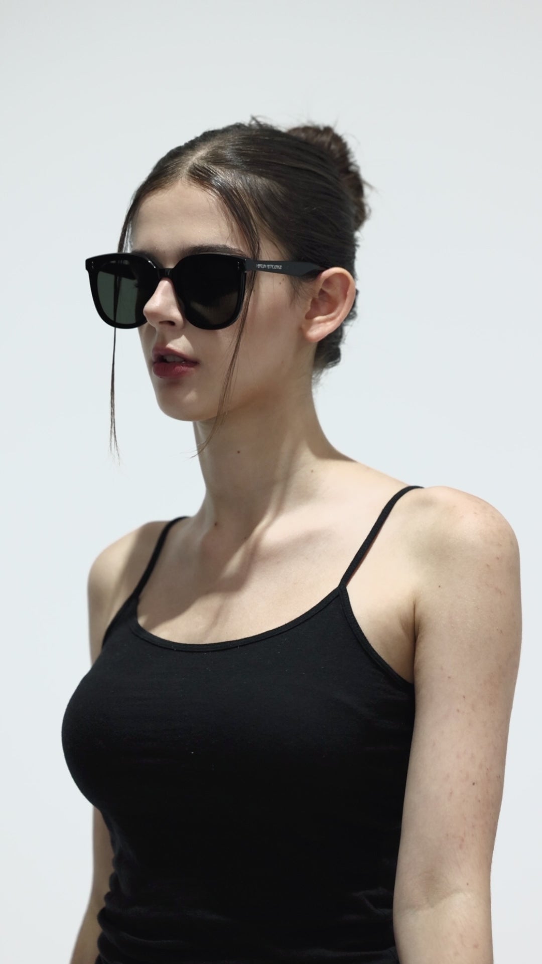 Walking model wearing Manta in black square fashion Sunglasses from Mercury Retrograde Burr Puzzle Collection 