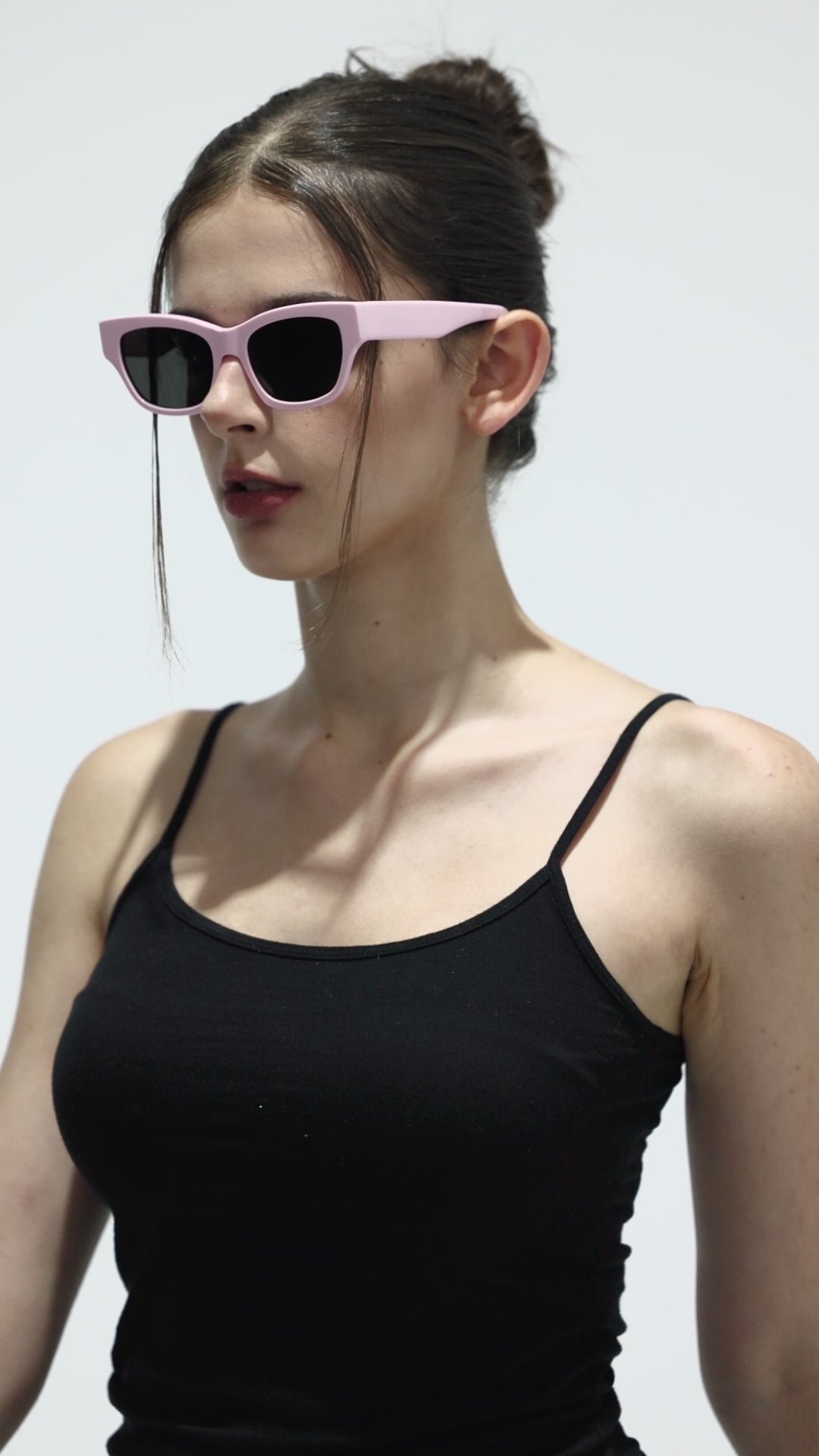 Walking model wearing Muse in pink square trendy Sunglasses from Mercury Retrograde Daydream Collection 