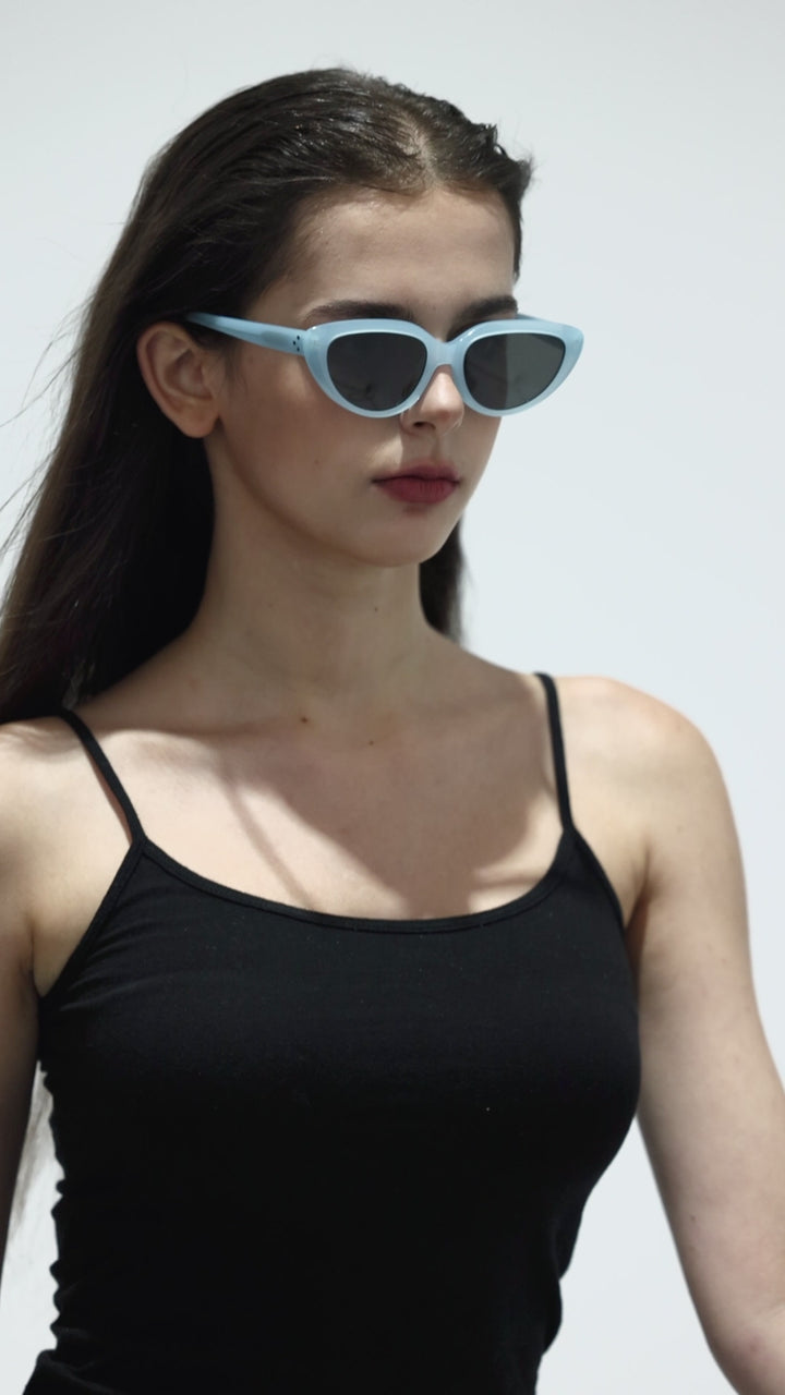 Walking model wearing BEBE Designer Sunglasses from Mercury Retrograde