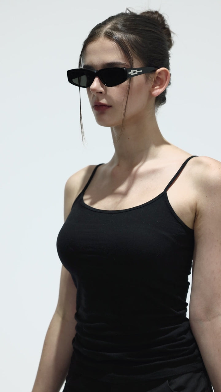Walking model wearing Hydrus in black square Designer Sunglasses from Mercury Retrograde Galaxy Collection 