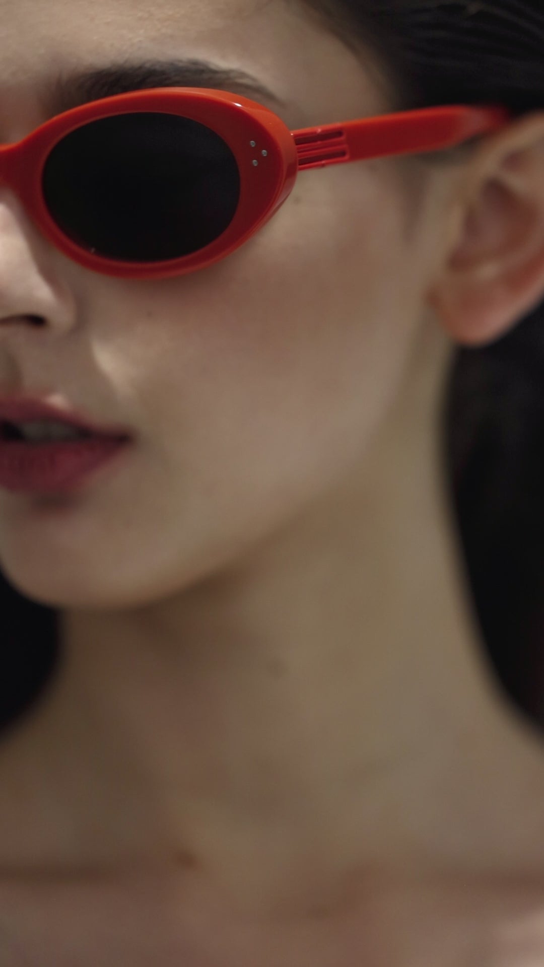 Close-up of walking model wearing Wave in red round  Designer Sunglasses from Mercury Retrograde Burr Puzzle Collection 