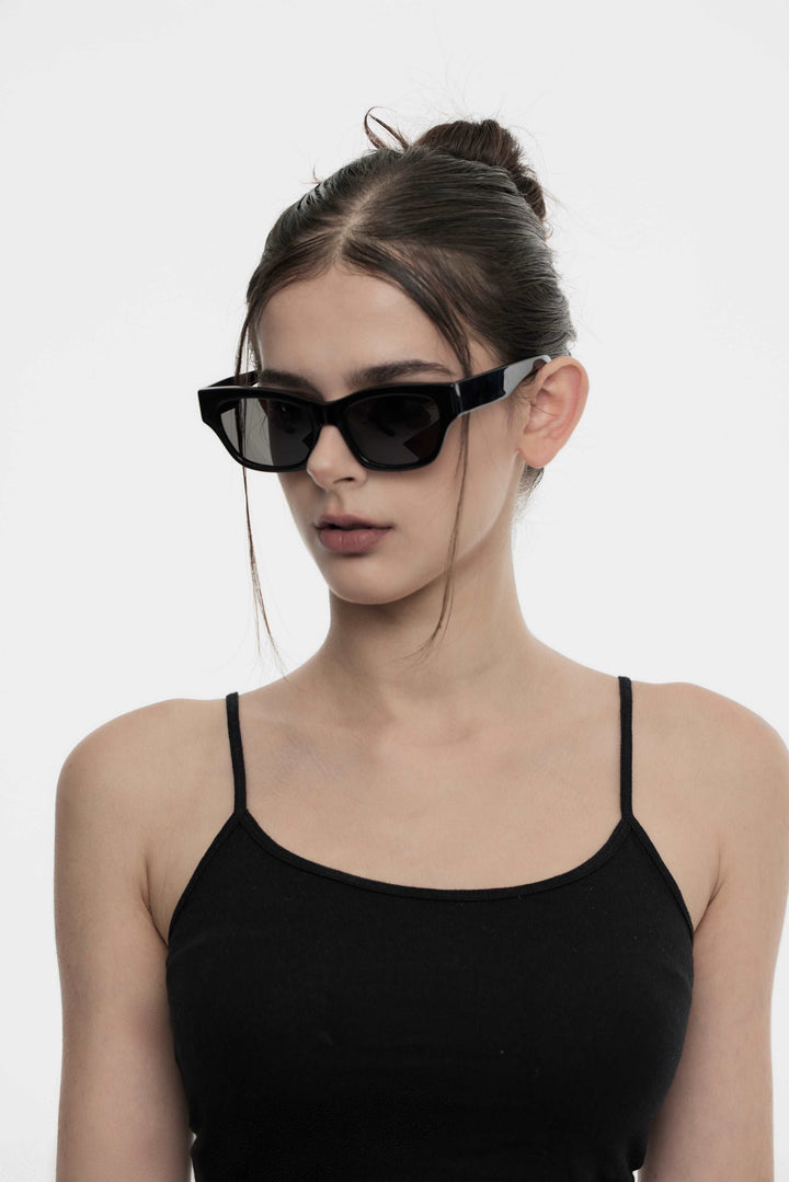 Model wearing Muse in black square Designer Sunglasses from Mercury Retrograde Daydream Collection 