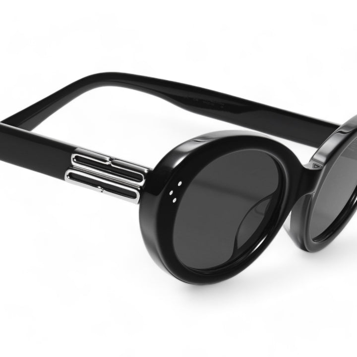 Close-up of Wave in black round Sunglasses lenses, high-quality eyewear by Mercury Retrograde Burr Puzzle Collection