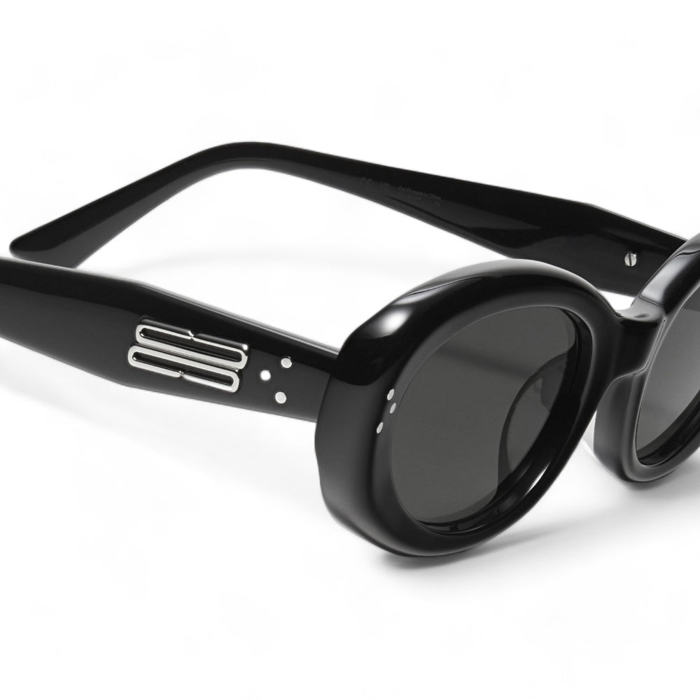 Close-up of Breath in black round Sunglasses lenses, stylish eyewear by Mercury Retrograde Burr Puzzle Collection