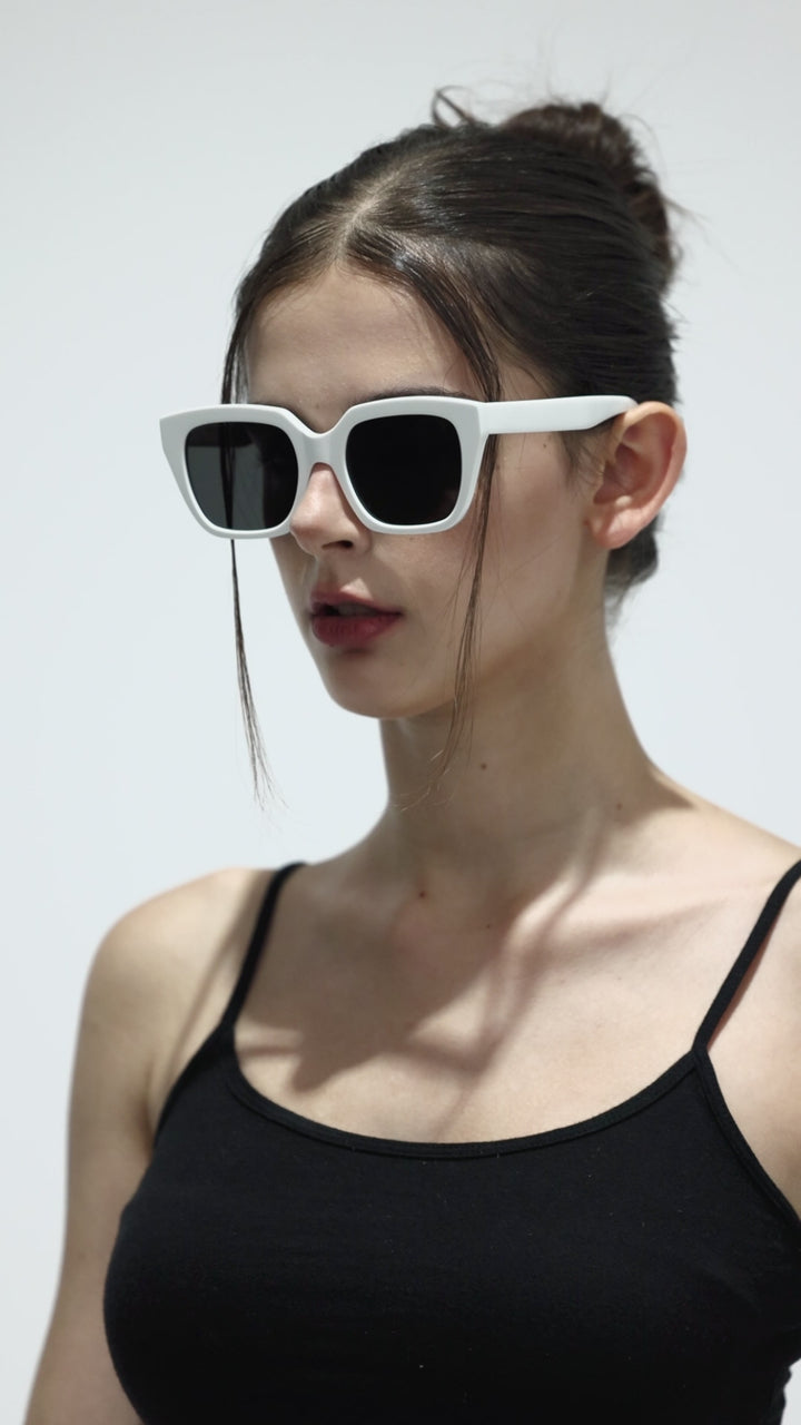 Walking model wearing Marshmallow in white square Designer Sunglasses from Mercury Retrograde Daydream Collection 